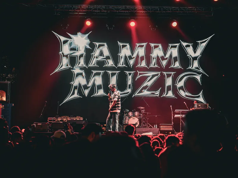 Wide view of a concert stage under red lights